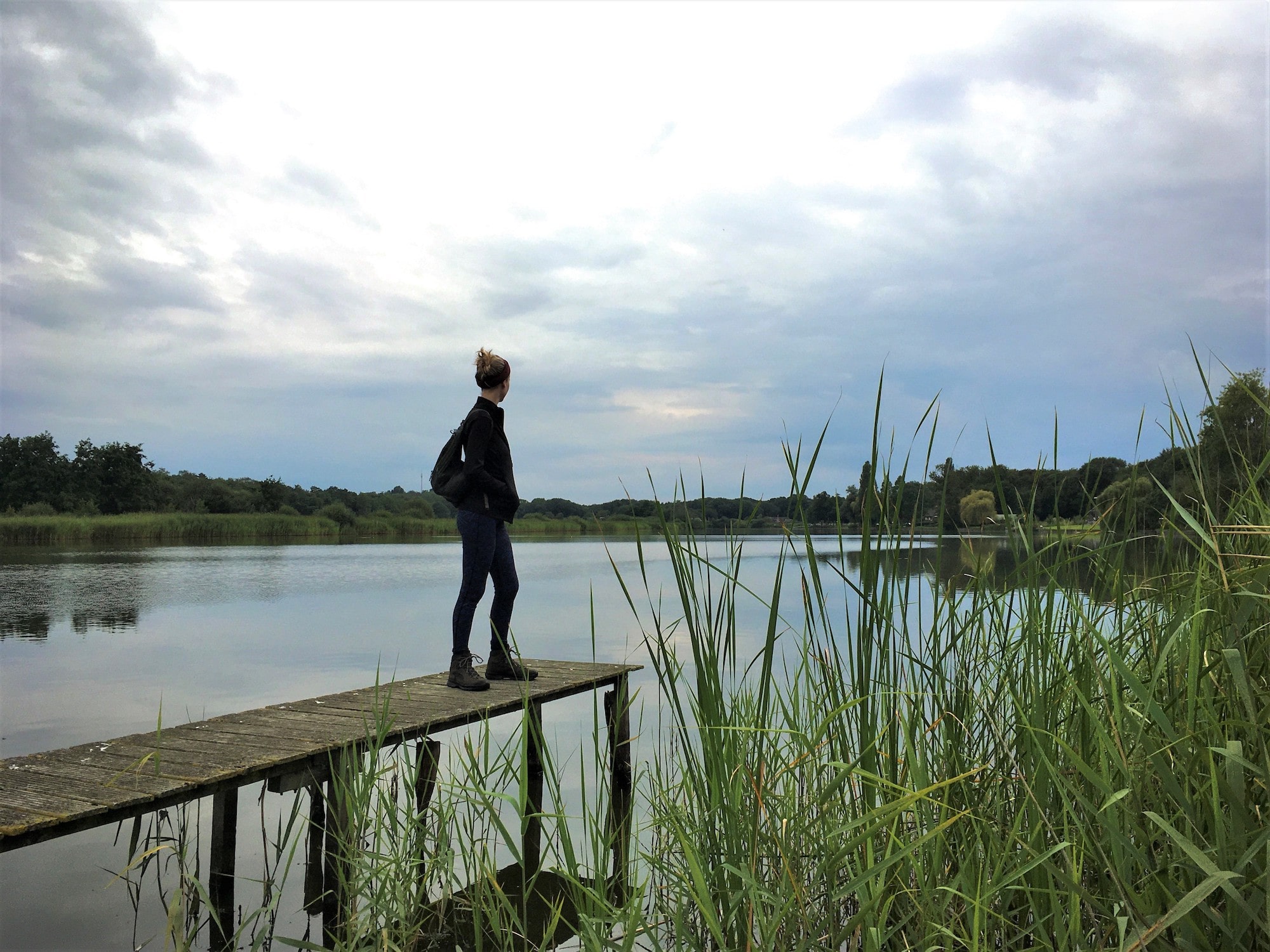 woman standing in front of lake